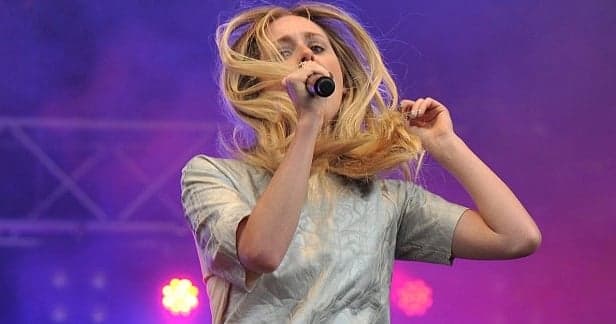 Singer Hits Bum Note On Stage, Literally