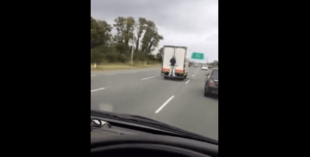VIDEO: Man Hitches A Lift On The Back Of Lorry Down The N7