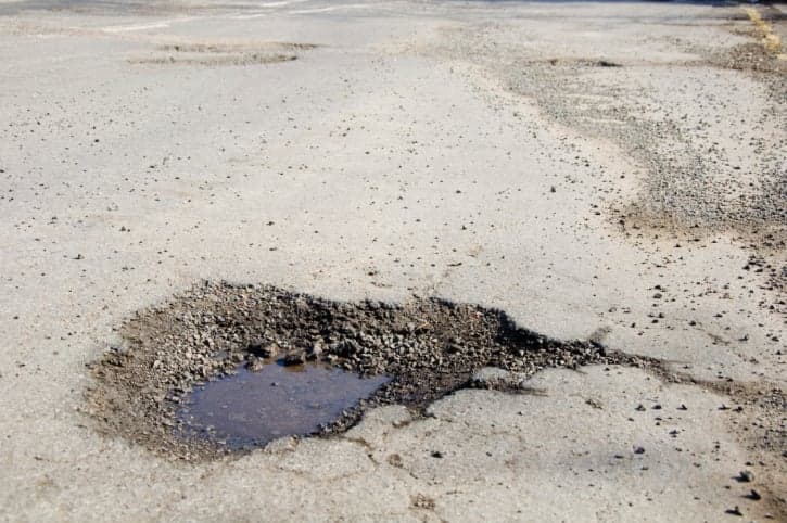 Drastic Action – Woman Proves Her Point By Taking A Bath In A Pothole
