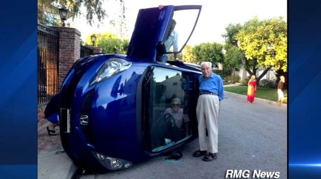 Pic Of The Day: Brilliant – Elderly Couple Pose For Photos After Car Overturns