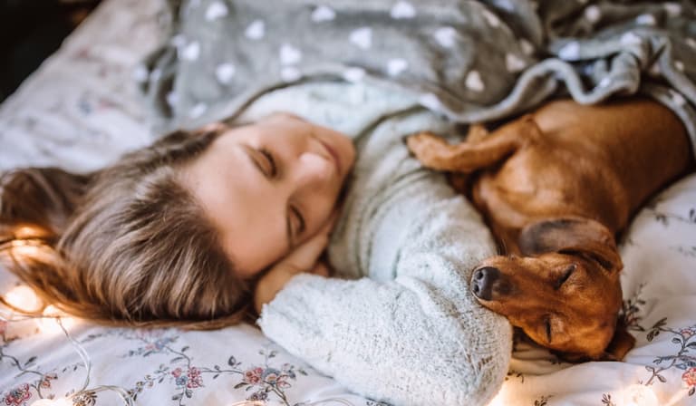 Women sleep better with a dog in their bed than a man, science says Women sleep better with a dog in their bed than a man, science says