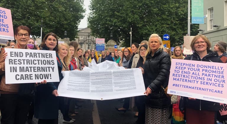 Hundreds gather outside Dáil Éireann to call for an end to maternity restrictions Hundreds gather outside Dáil Éireann to call for an end to maternity restrictions