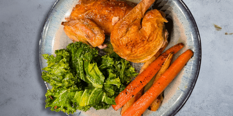 Air-fried carrots, parsnips, and crunchy kale paired with crispy chicken– A modern comfort classic