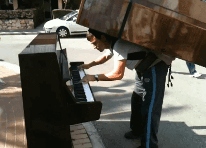 VIDEO: Man Plays Piano While Balancing Another Piano on His Back VIDEO: Man Plays Piano While Balancing Another Piano on His Back