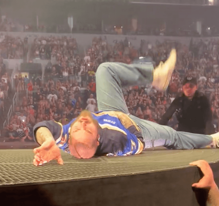 Post Malone dramatically falls through stage during concert Post Malone dramatically falls through stage during concert